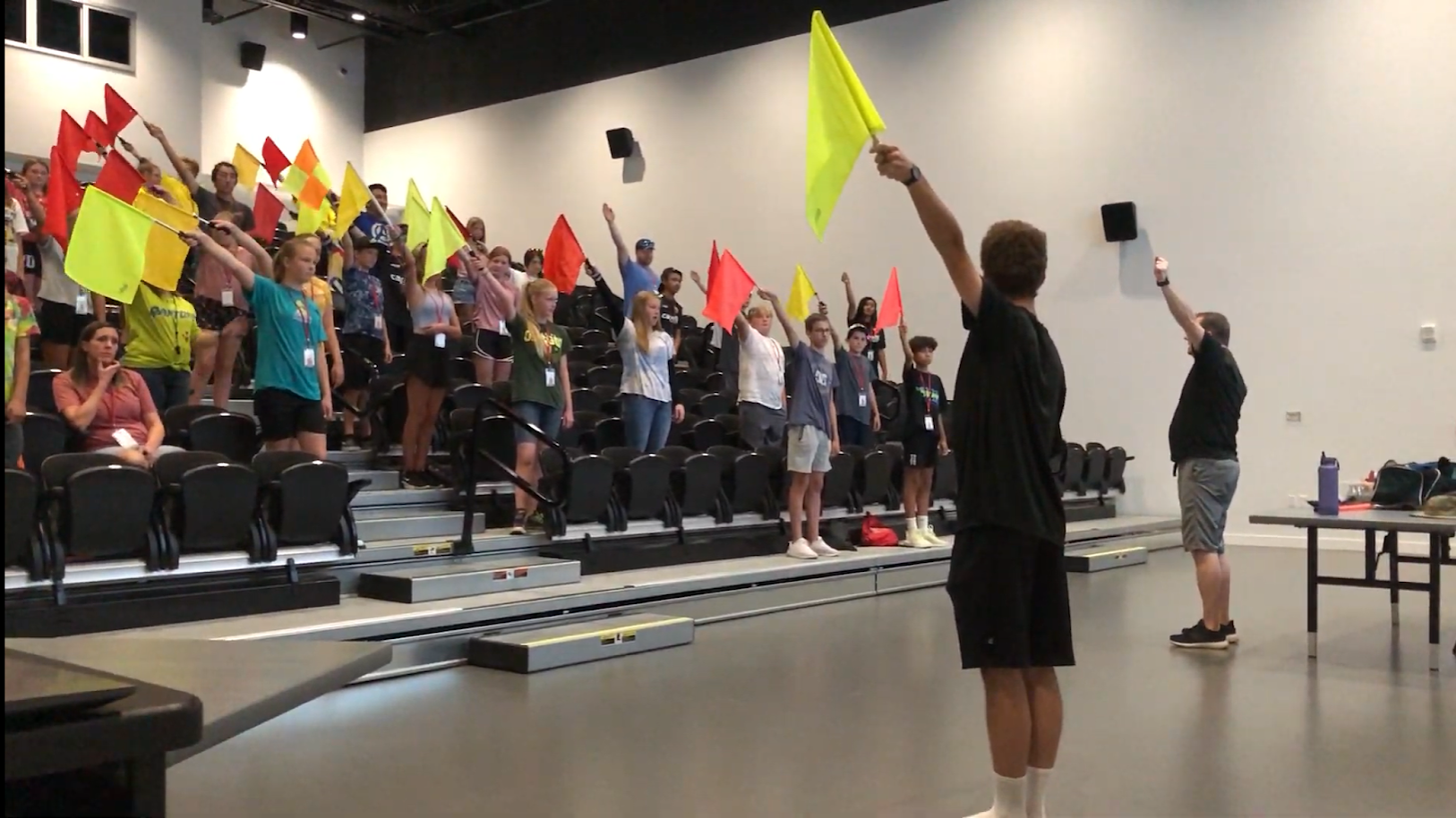 IREF clinic instructor working with young referees on the field