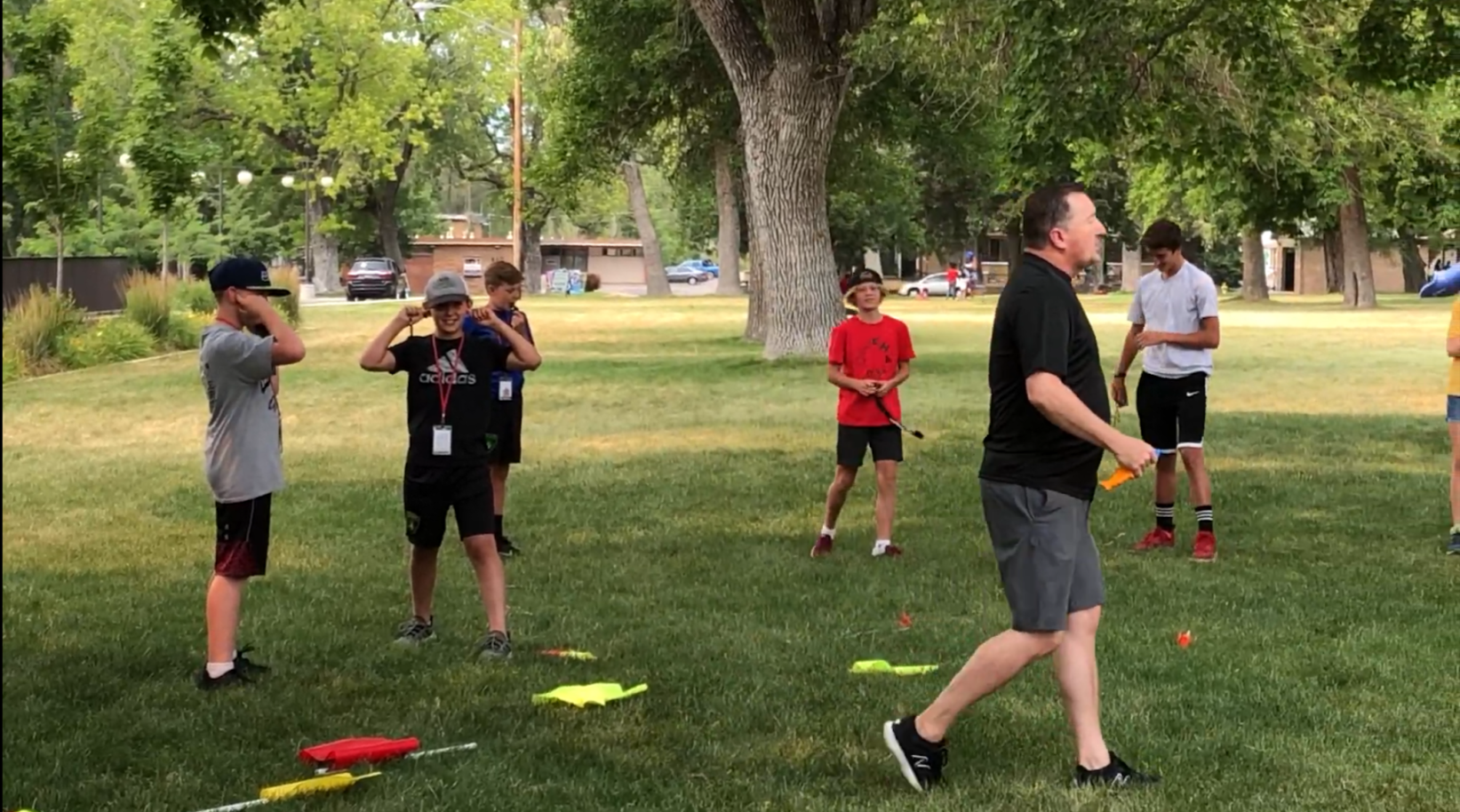 Mark walking past a row of referees during an on-field IREF clinic